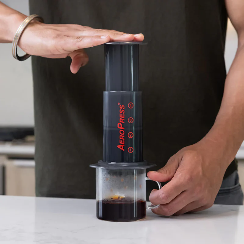 A coffee lover preparing to brew coffee with an AeroPress.